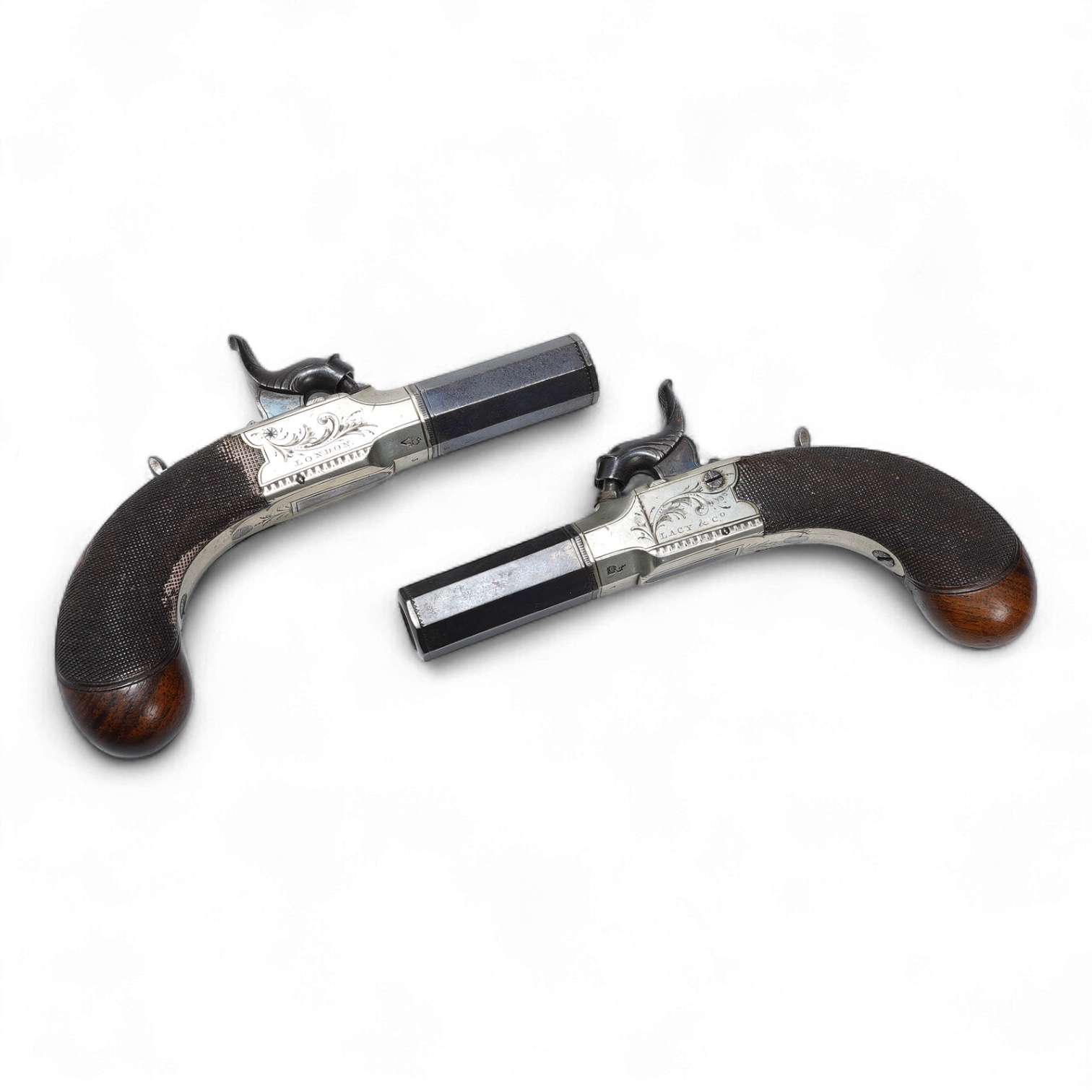 A pair of boxlock percussion pocket pistols with 4cm octagonal barrels, the frames engraved Lacy & Co., London, with London proof marks and rounded chequered walnut butts (2)